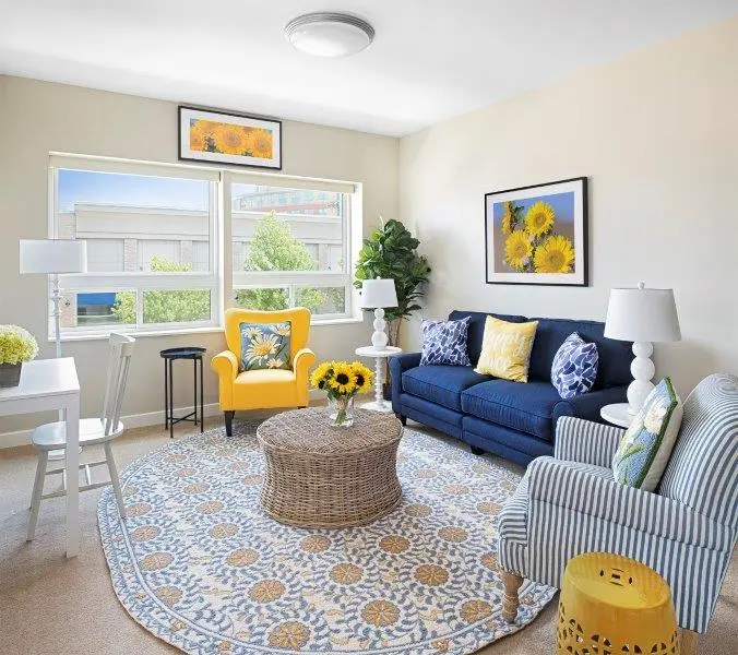 Furnished apartment with blue and yellow décor at senior living community in Wyoming, MI